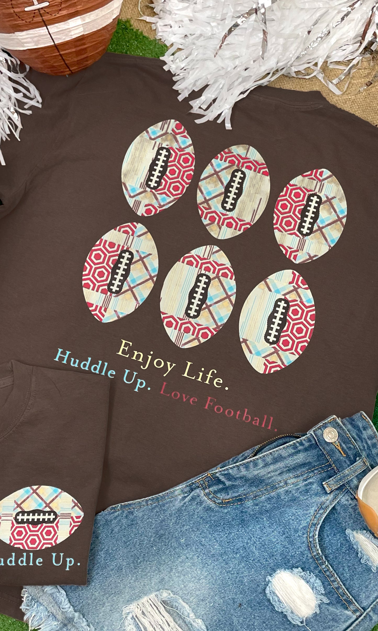 Huddle Up Love Football Graphic Shirt featuring football designs and playful text, perfect for game day style.