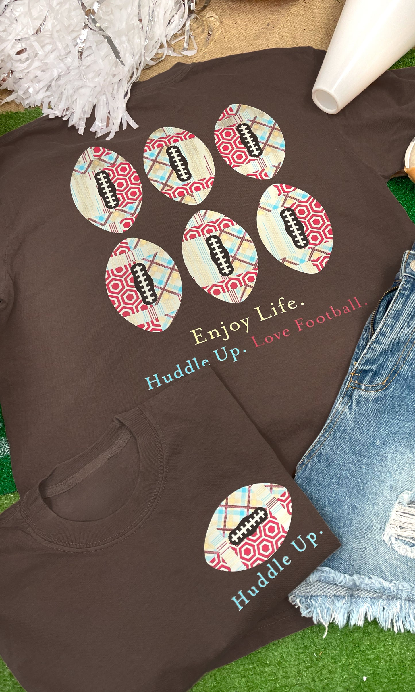 Huddle Up Love Football Graphic Shirt features a fun design perfect for game day, showcasing footballs and a positive message.