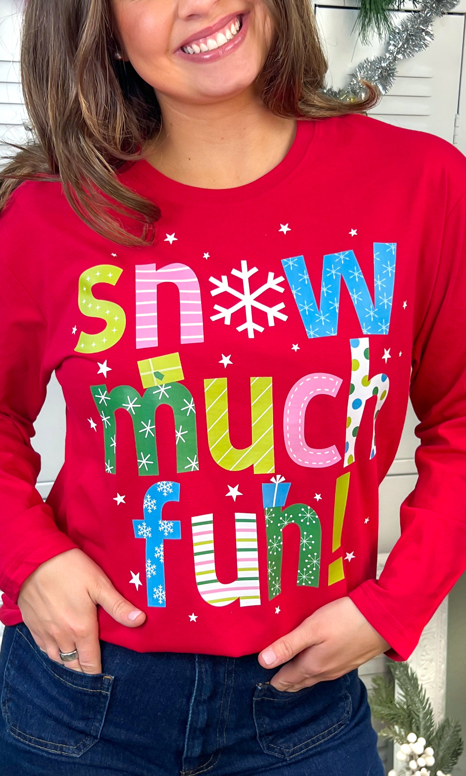 Bright red Snow Much Fun Christmas Graphic Long Sleeve T-Shirt features playful text and festive designs for holiday cheer.