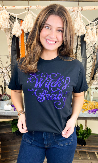 Stylish model wearing a Witch's Brew Halloween Graphic Shirt, perfect for festive celebrations and spooky vibes.