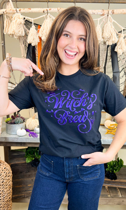 Stylish Witch's Brew Halloween Graphic Shirt showcased by a model for festive fall wardrobe essentials.
